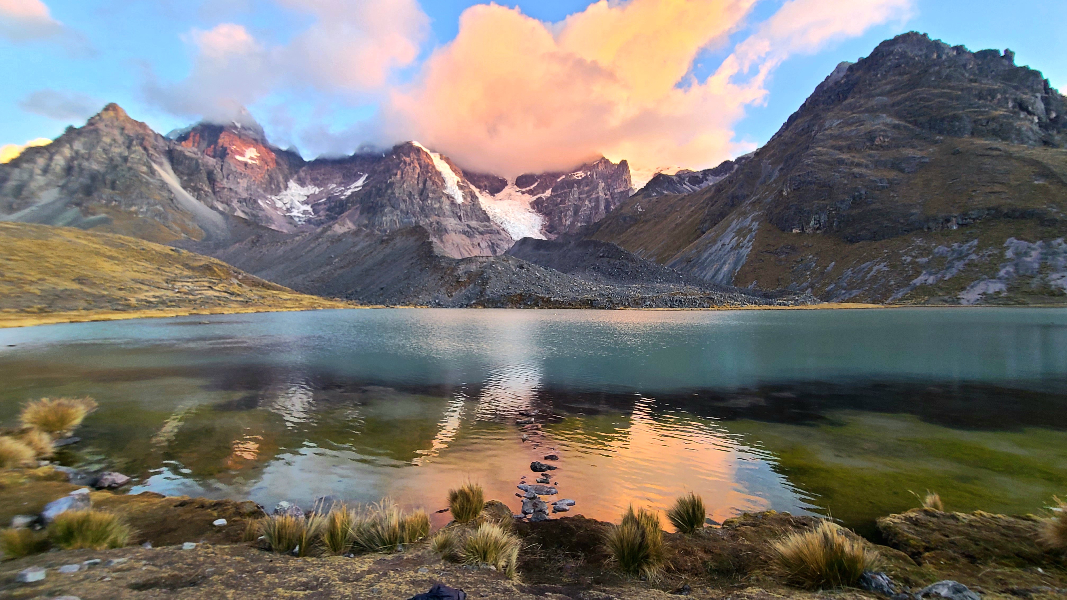   2nd Place: Katie Foster  Mama Qocha, Tayta Urqu: a snow-capped mountain is reflected in an alpine lagoon in the southern Andes of Peru at sunset. Glacial meltwater is the primary source of drinking water in the Andes, especially during the dry season. Lakes and mountains are respected and revered across the region.