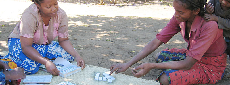A Masikoro woman chooses one among four dominoes