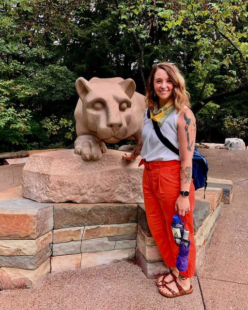 Isabelle Holland-Lulewicz standing next to Penn state mascot statue
