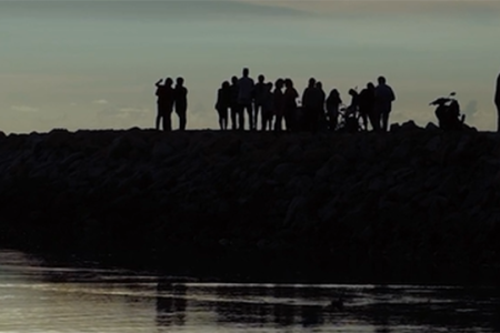 people on small jut of land