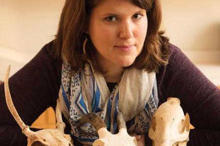 Suzanne Pilaaar Birch, faculty in both anthropology and geology, with animal skulls from a research collection.